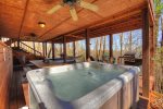 Outdoor hot tub with gas grill near by